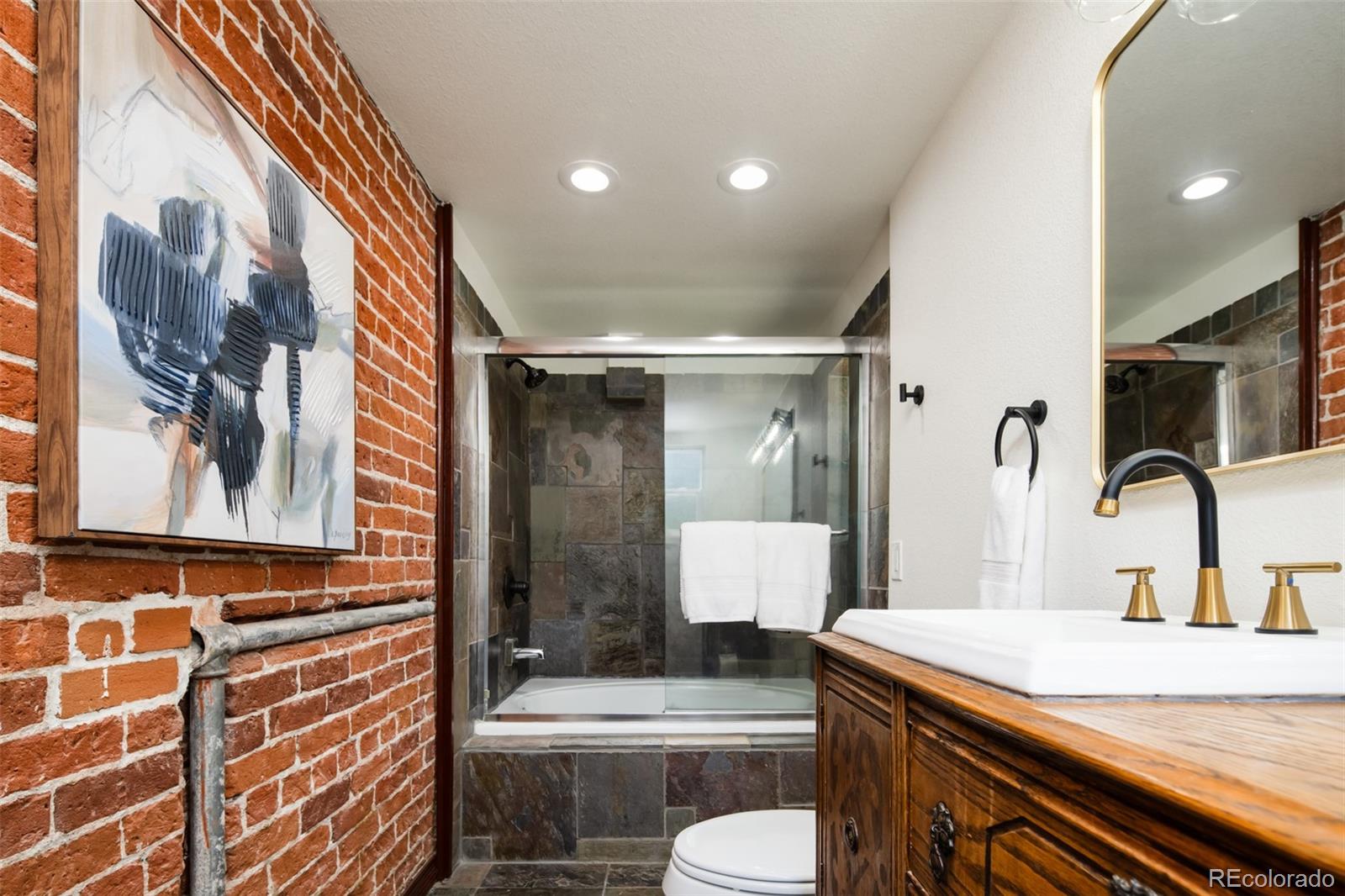 3519 L Newton Street Denver, CO 80211 - Photo 24 of 40 a bathroom with a sink a toilet and shower