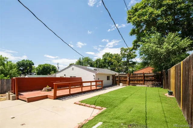 a view of a house with backyard and a patio