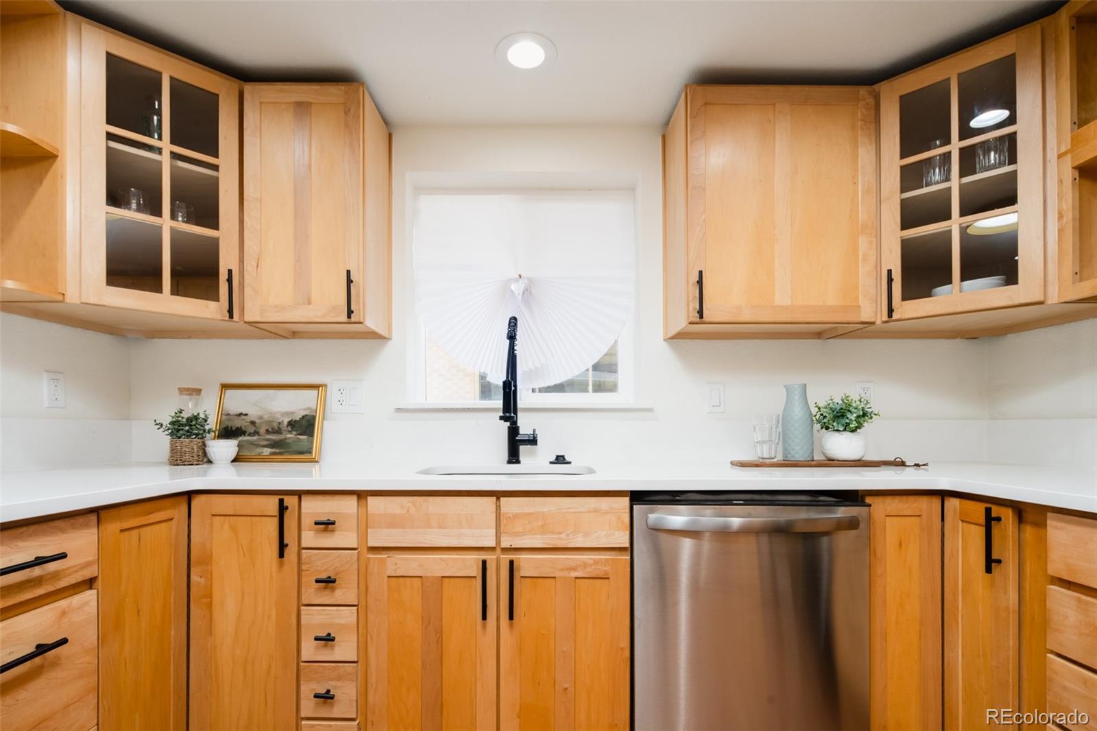 3519 L Newton Street Denver, CO 80211 - Photo 7 of 40 a kitchen with stainless steel appliances granite countertop a sink and cabinets