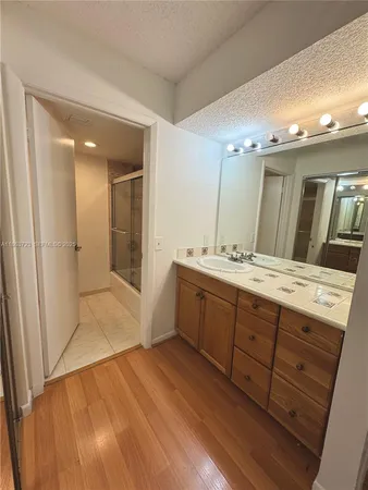 a spacious bathroom with a double vanity sink and a mirror