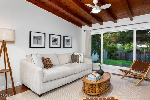 a view of living room with furniture and wooden floor