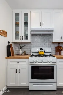 a bedroom with a bed and glass window