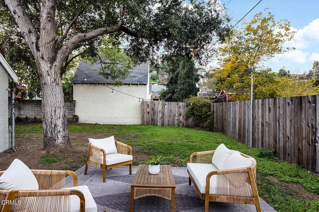 a view of a backyard with sitting area