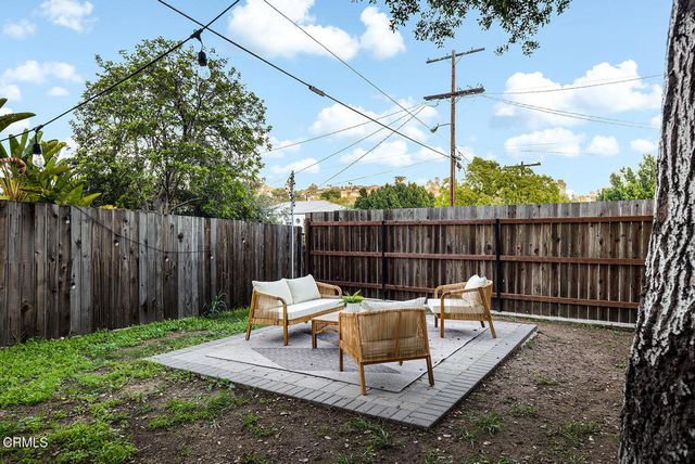 a backyard of a house with a tree