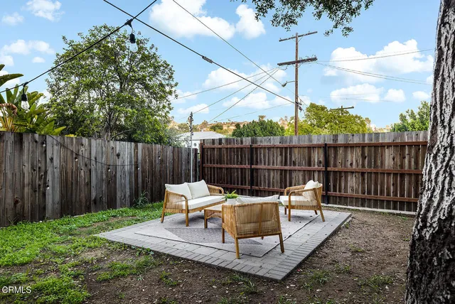 a backyard of a house with a tree