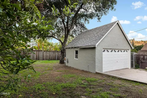 a view of a patio with a table chairs and a fire pit