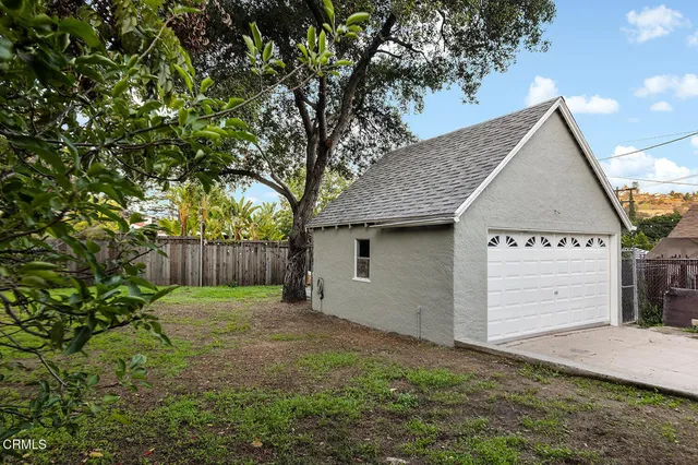 a view of a patio with a table chairs and a fire pit