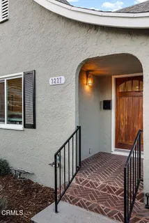 a view of a livingroom with entryway and stairs