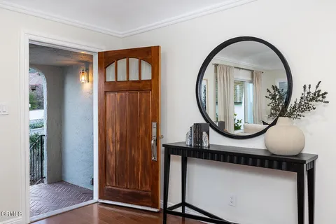 a living room with furniture a fireplace and a large window