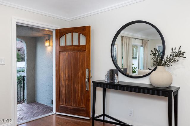 a living room with furniture a fireplace and a large window