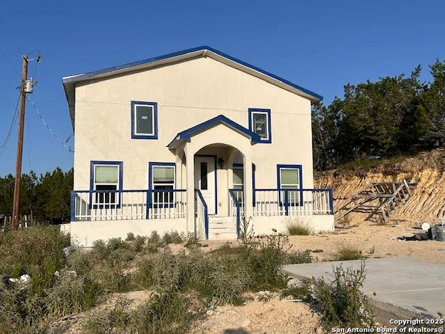 a front view of house along with trees