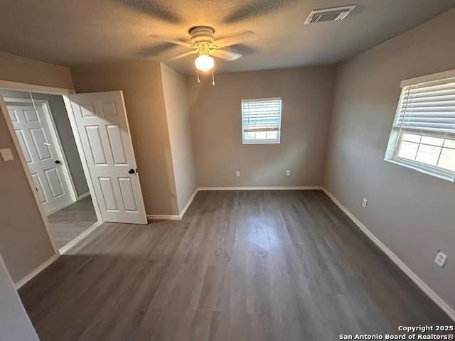 236 Hopi Bandera, TX 78003 - Photo 13 of 34 wooden floor in an empty room with a window