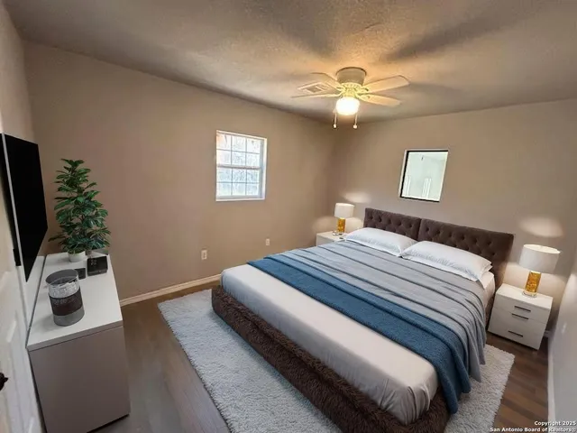 a bedroom with a bed and a flat screen tv