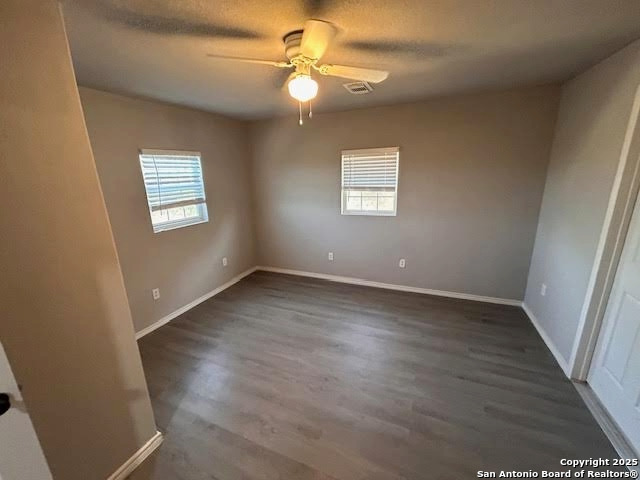 236 Hopi Bandera, TX 78003 - Photo 32 of 34 an empty room with wooden floor fan and windows