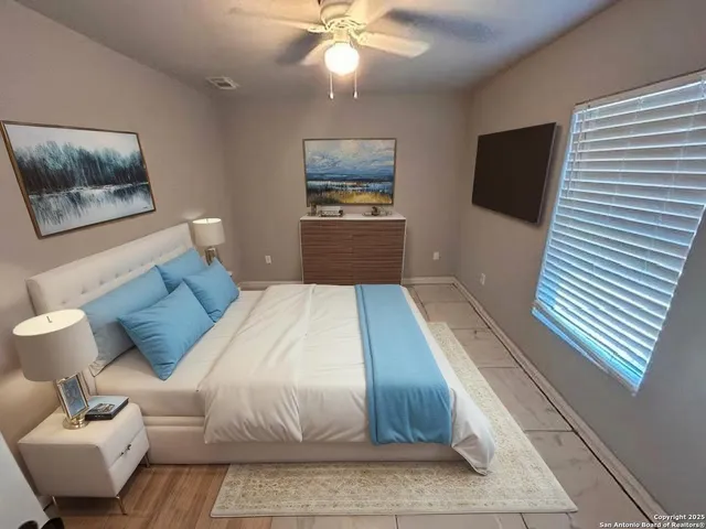 a bedroom with a bed and a mirror