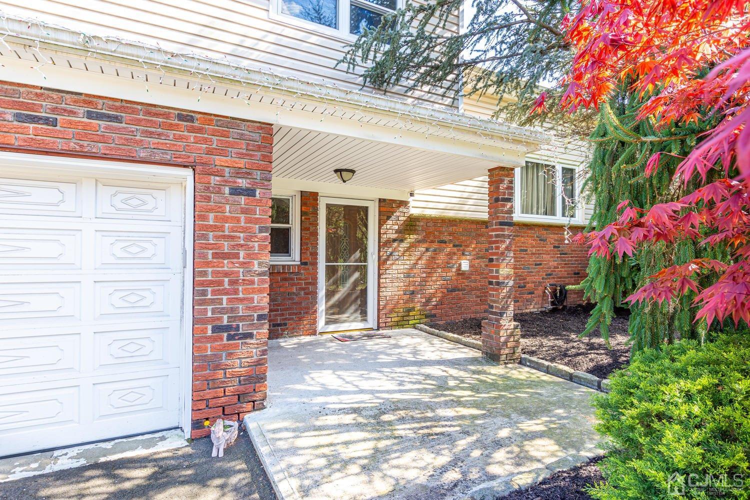 983 New Dover Road Edison, NJ 08820 - Photo 2 of 25 a front view of a house with a garden