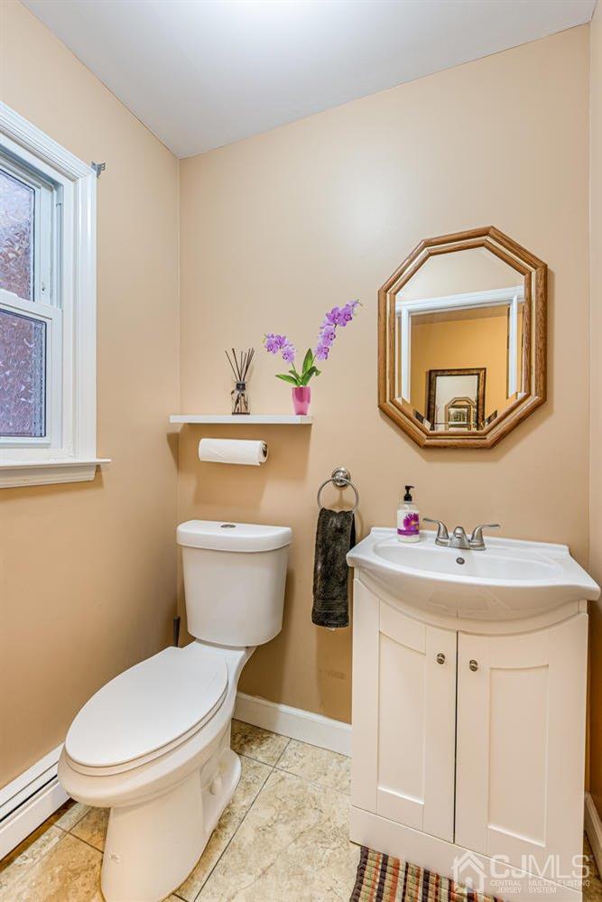 983 New Dover Road Edison, NJ 08820 - Photo 11 of 25 a bathroom with a toilet sink and mirror
