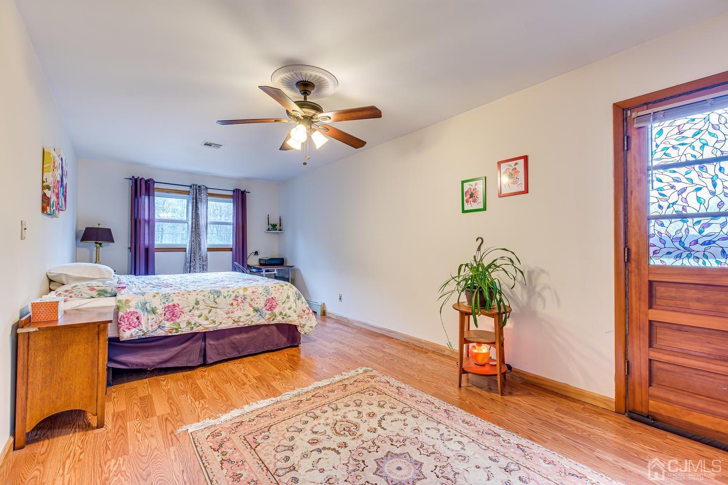 983 New Dover Road Edison, NJ 08820 - Photo 12 of 25 a bedroom with a bed and a potted plant