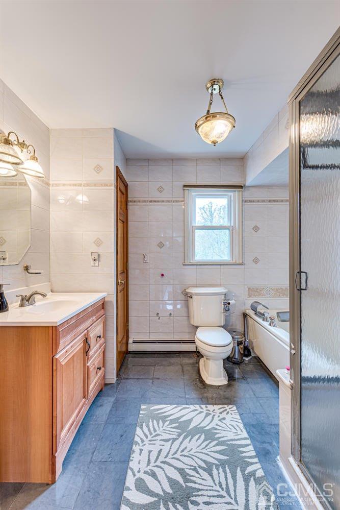 983 New Dover Road Edison, NJ 08820 - Photo 14 of 25 a bathroom with a toilet sink and mirror