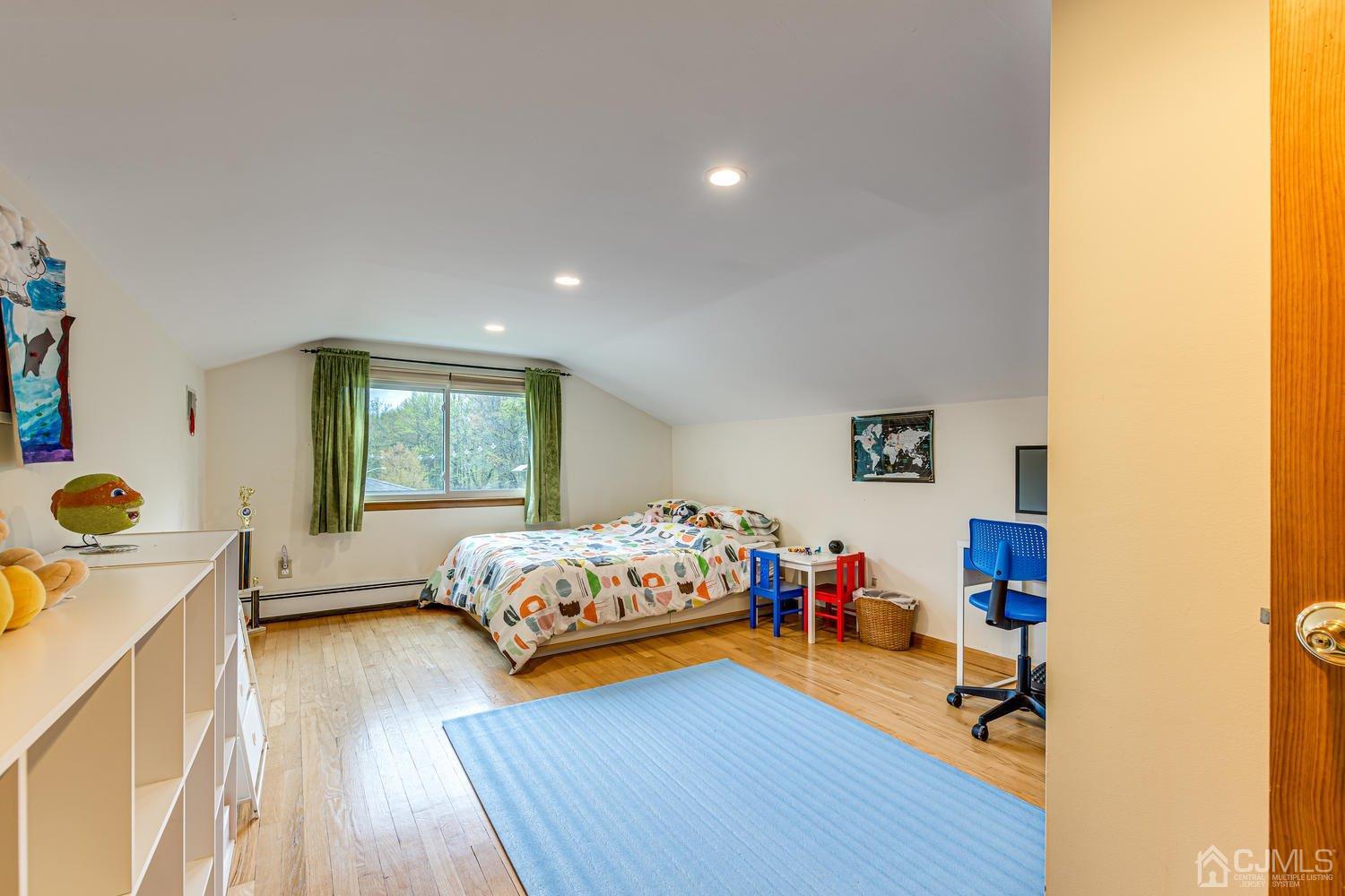 983 New Dover Road Edison, NJ 08820 - Photo 16 of 25 a bedroom with a bed and wooden floor