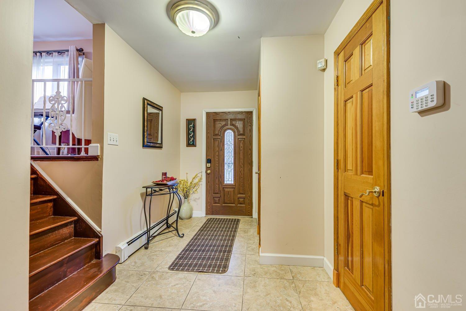983 New Dover Road Edison, NJ 08820 - Photo 3 of 25 a view of a hallway with windows and stairs