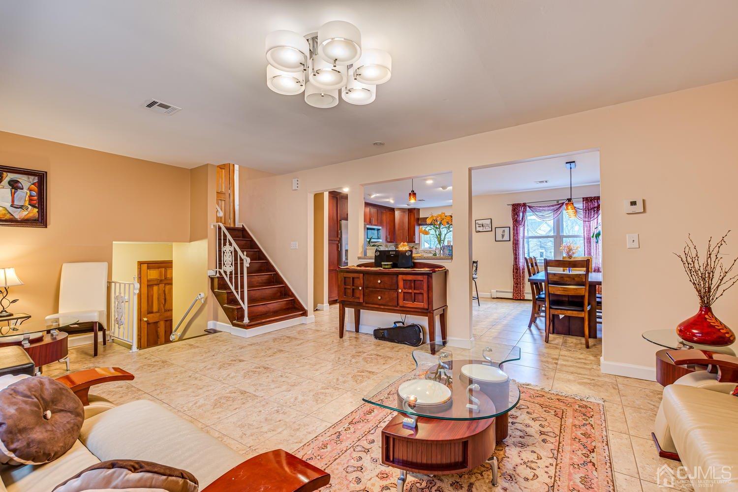 983 New Dover Road Edison, NJ 08820 - Photo 5 of 25 a living room with furniture and a chandelier