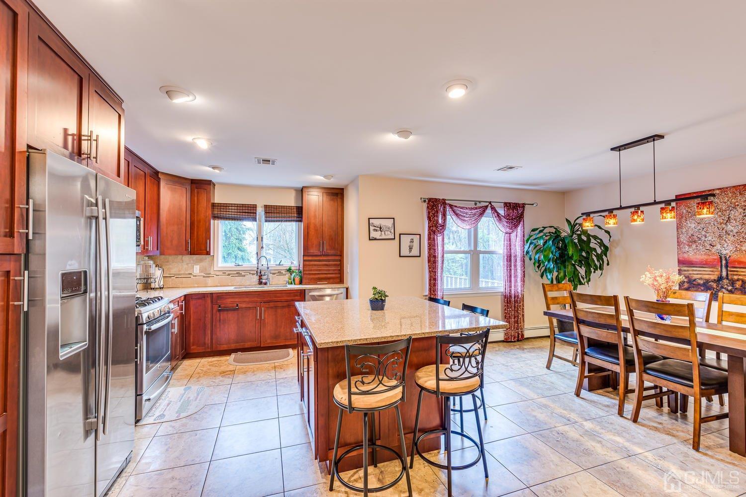 983 New Dover Road Edison, NJ 08820 - Photo 7 of 25 a large kitchen with a table and chairs