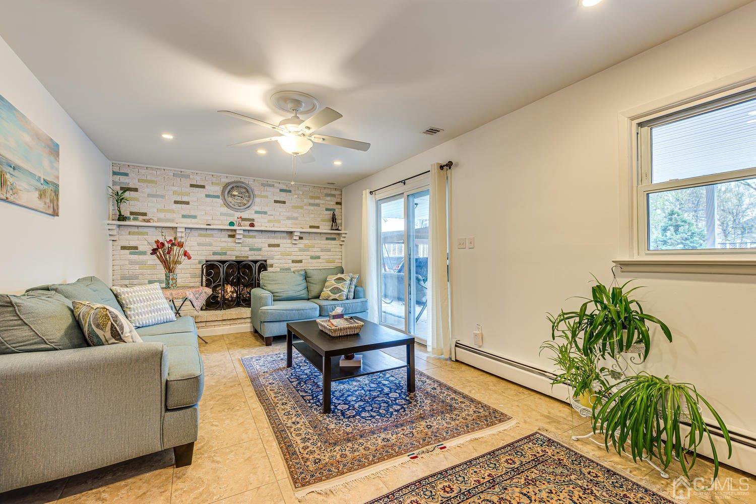 983 New Dover Road Edison, NJ 08820 - Photo 10 of 25 a living room with furniture fireplace and a window