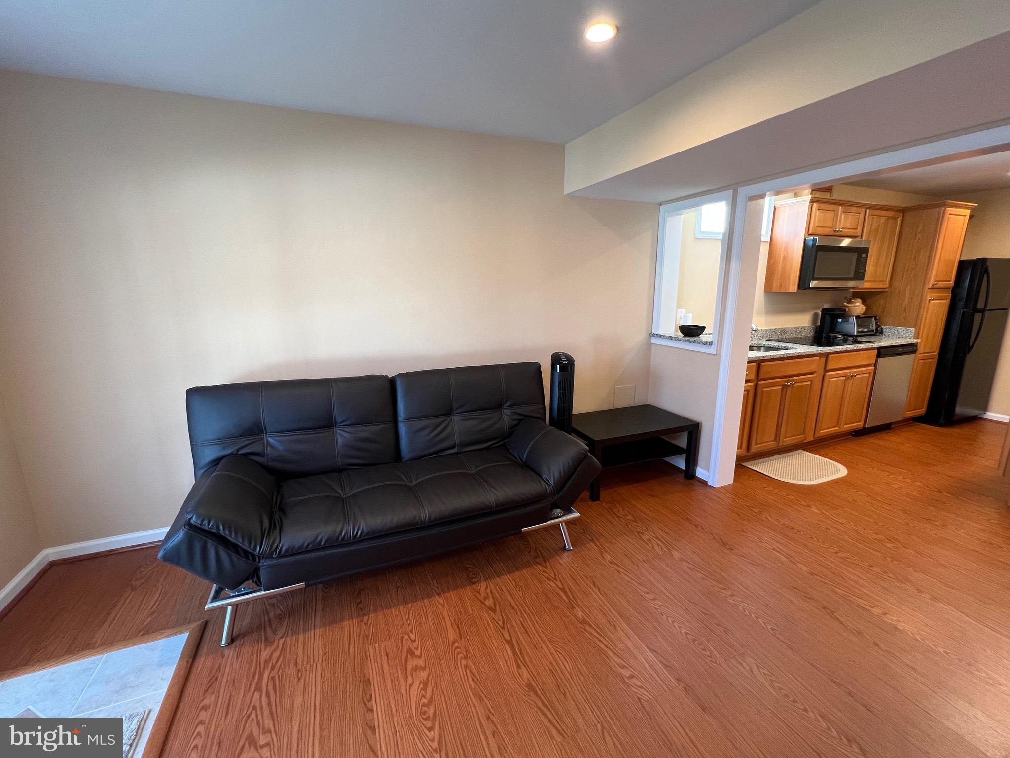 5802 Telluride Lane, Unit BASEMENT APARTMENT Spotsylvania, VA 22553 - Photo 12 of 35 a living room with furniture and a wooden floor