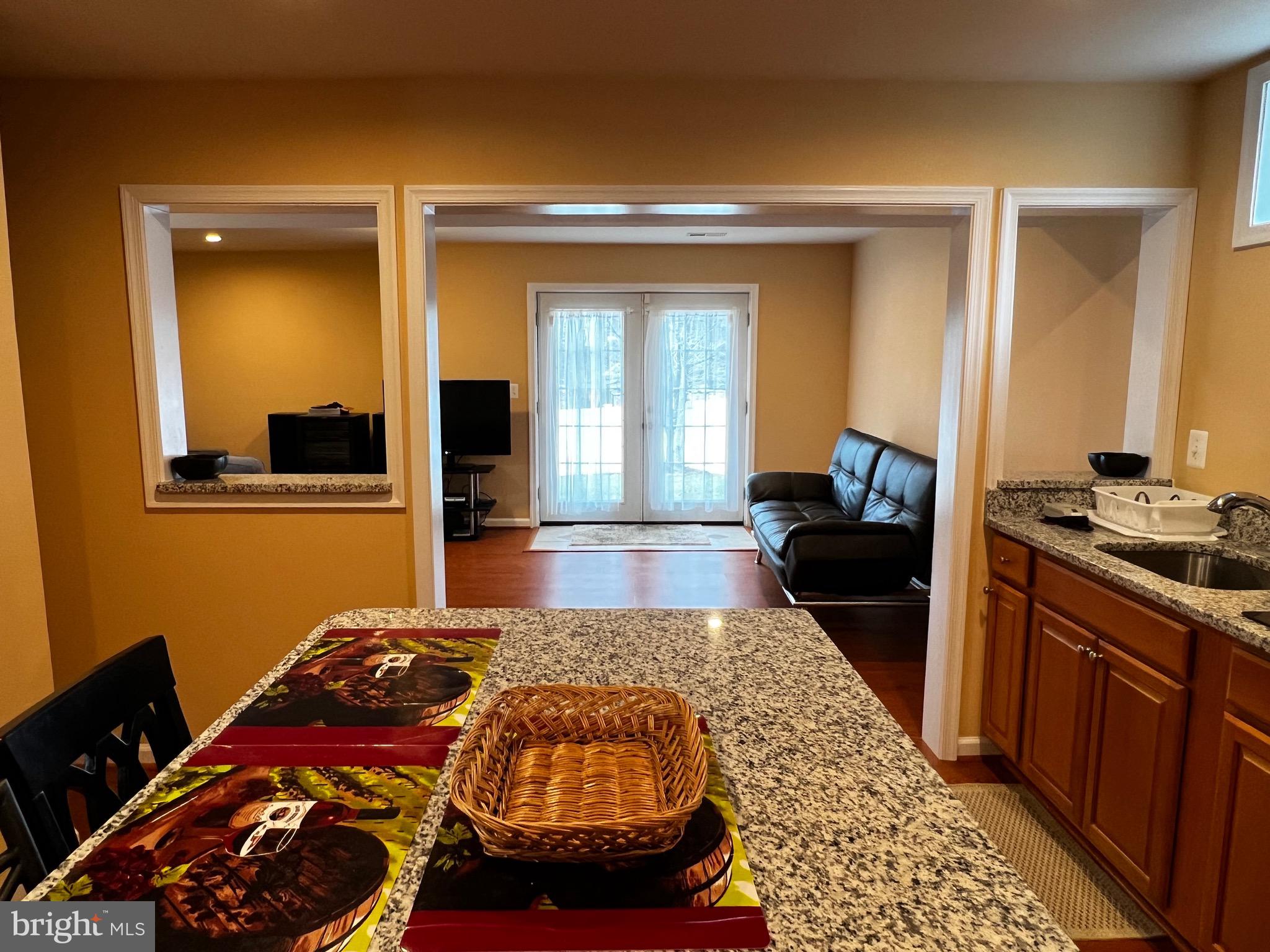 5802 Telluride Lane, Unit BASEMENT APARTMENT Spotsylvania, VA 22553 - Photo 17 of 35 a bedroom with a bed and wooden floor