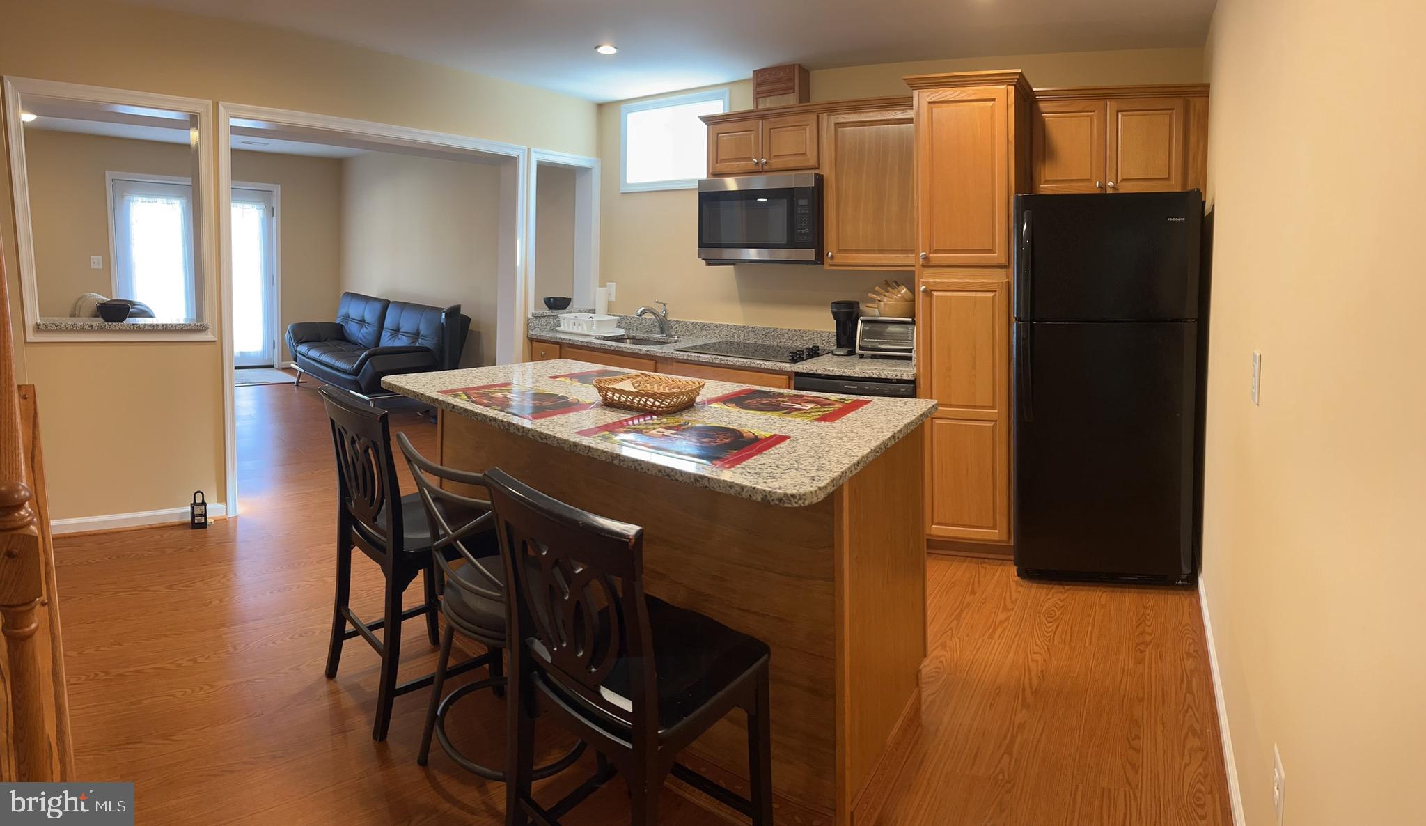 5802 Telluride Lane, Unit BASEMENT APARTMENT Spotsylvania, VA 22553 - Photo 18 of 35 a kitchen with stainless steel appliances granite countertop a stove refrigerator sink and microwave