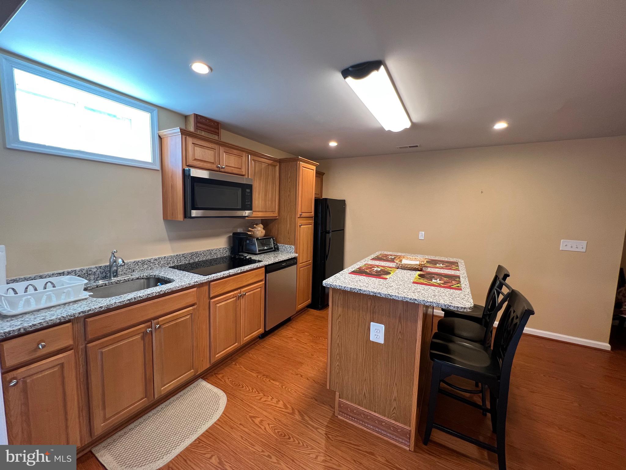 5802 Telluride Lane, Unit BASEMENT APARTMENT Spotsylvania, VA 22553 - Photo 2 of 35 a kitchen that has a cabinets and a stove top oven