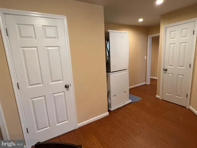 a view of a kitchen with wooden floor and a refrigerator