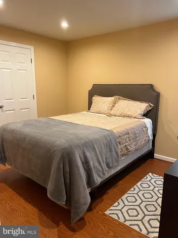 a bedroom with a bed and a night stand