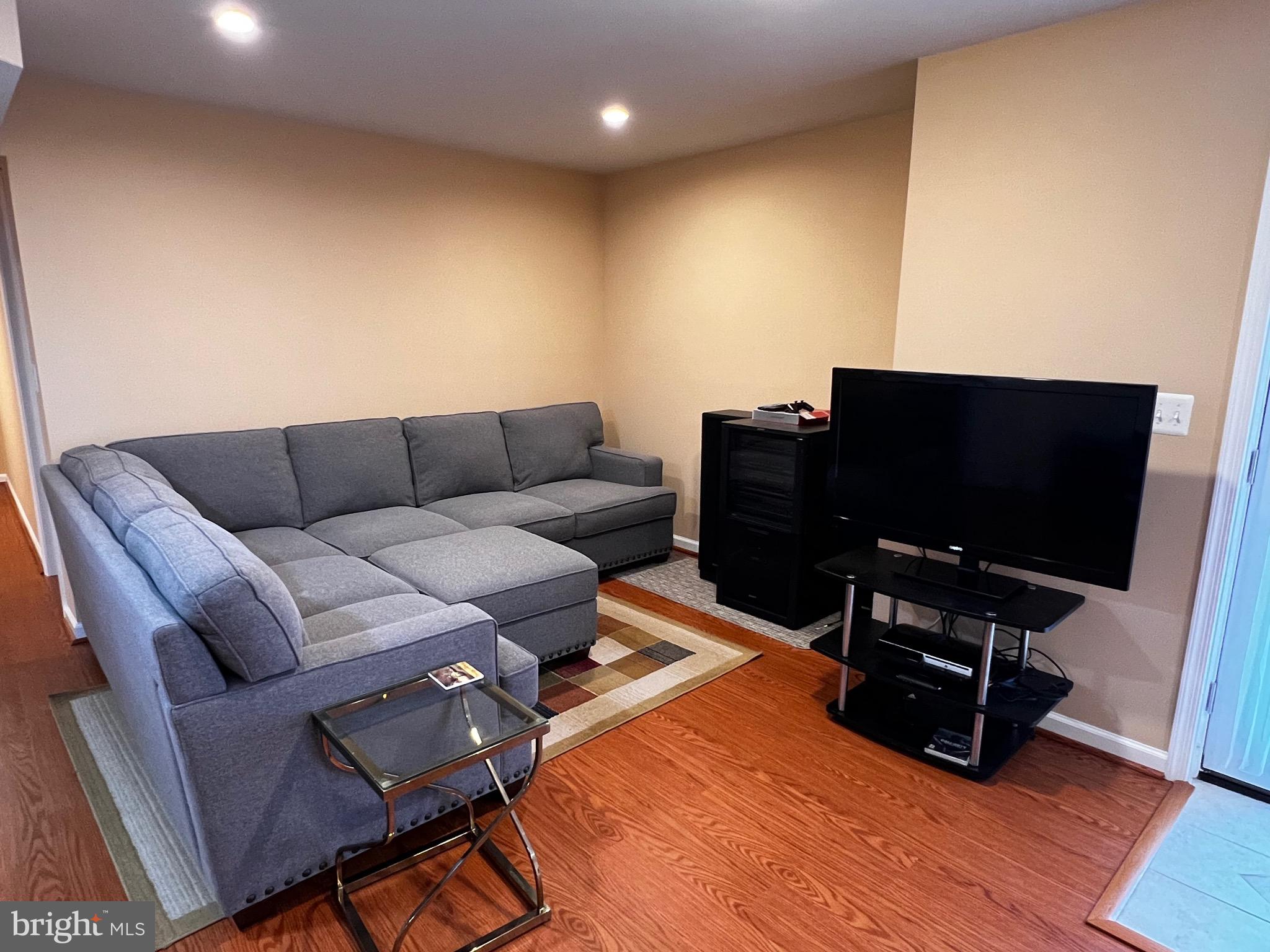 5802 Telluride Lane, Unit BASEMENT APARTMENT Spotsylvania, VA 22553 - Photo 8 of 35 a living room with furniture and a flat screen tv