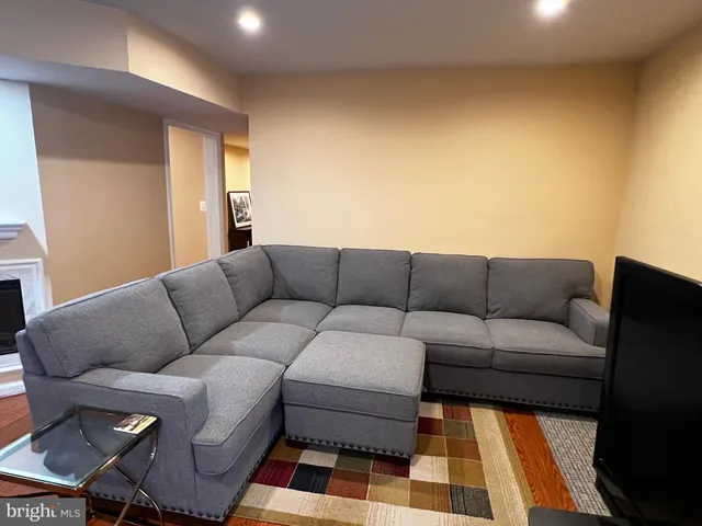 a living room with a couch and a rug
