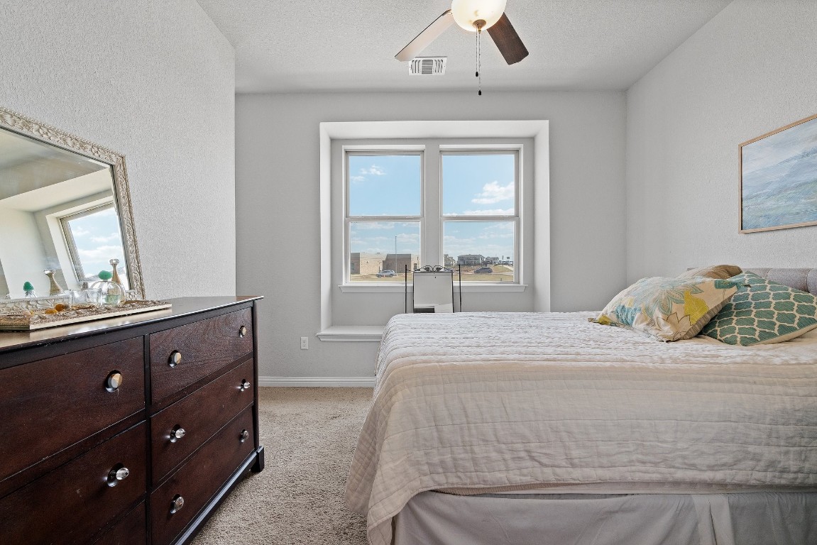 8002 Mandela Bend Austin, TX 78744 - Photo 13 of 24 a bedroom with a bed and a window