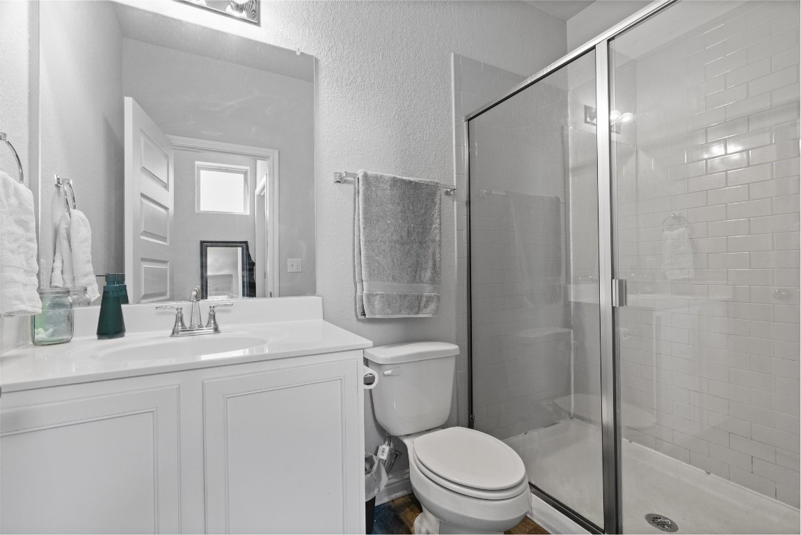 8002 Mandela Bend Austin, TX 78744 - Photo 14 of 24 a bathroom with a sink toilet vanity and shower
