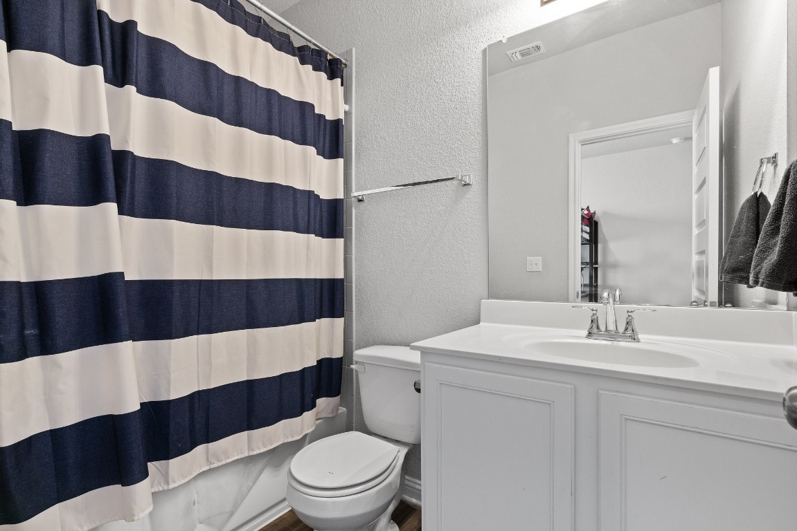 8002 Mandela Bend Austin, TX 78744 - Photo 16 of 24 a bathroom with a sink a toilet a shower and a mirror