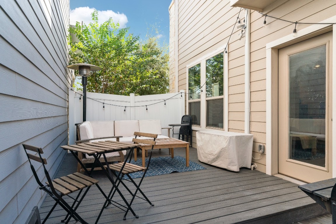8002 Mandela Bend Austin, TX 78744 - Photo 17 of 24 a backyard of a house with wooden floor table and chairs