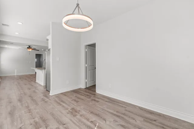 a view of a room with wooden floor and a sink