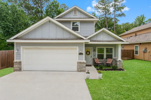 a front view of a house with a garden and yard