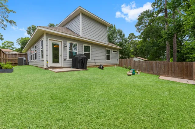 a view of a house with a yard and sitting area