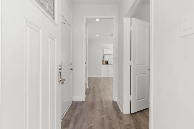 a view of a hallway with wooden floor