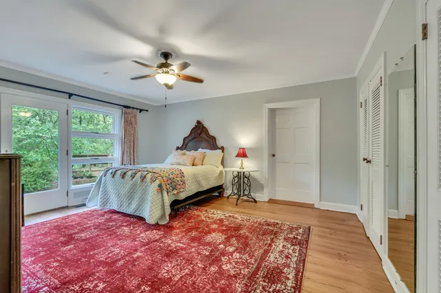 a bedroom with bed and a chandelier