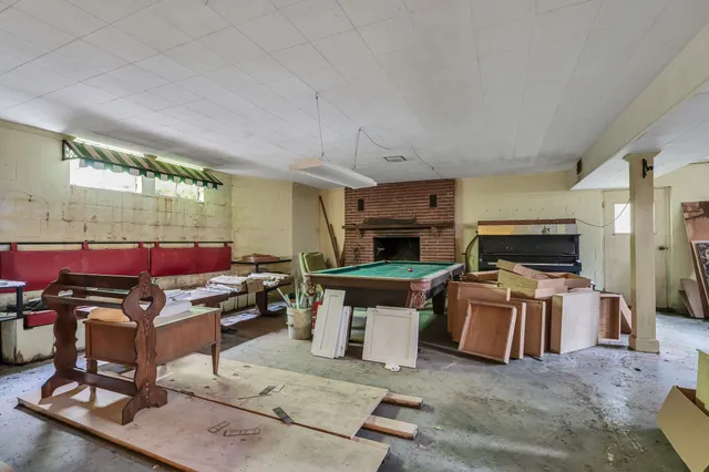 a living room with furniture a rug and a lamp