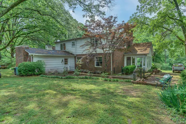 a living room with fireplace furniture and a rug