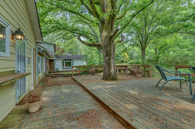 a view of a dining room with furniture a chandelier and wooden floor