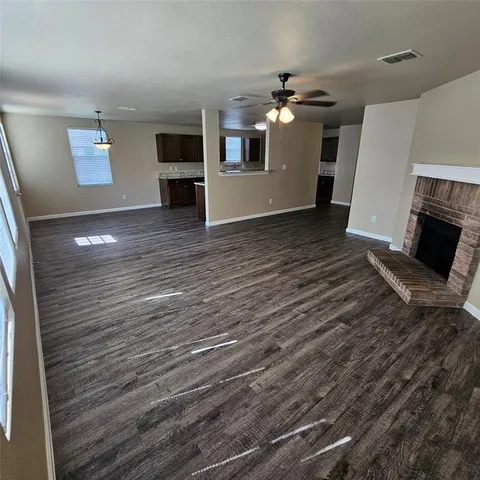 an empty room with wooden floor