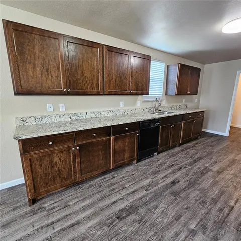 a kitchen with stainless steel appliances granite countertop a sink and stove top oven